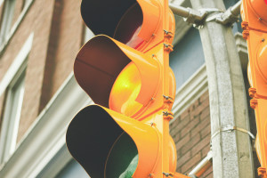 close up of streetlight with yellow light illuminated