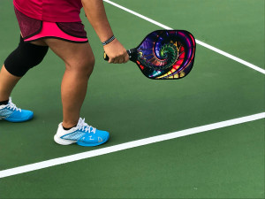 close up of pickleball racket in player's hand