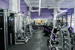 gym equipment in bright white and purple gym space